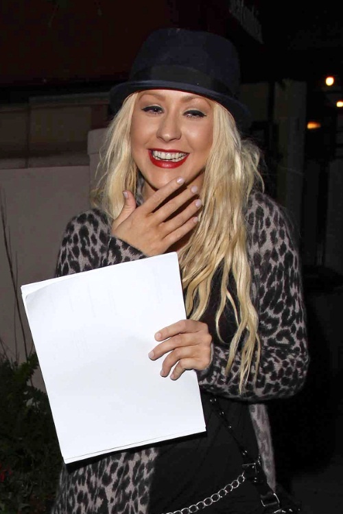 45322, LOS ANGELES, CALIFORNIA - Wednesday September 21 2010. Christina Aguilera enjoys a night out with her husband Jordan Bratman at Matsuhisa in Beverly Hills. The songstress covered her face with some white paper as she left the trendy eatery but as she walked down the street towards her car she very purposefully hid her stomach from view - could Xtina be pregnant with a sibling for two-year-old Max?!! Photograph:  Devone Byrd, PacificCoastNews.com
