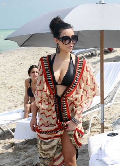 TV Star Kim Kardashian smiled for the cameras while she dipped her feet into the ocean before leaving the beach in Miami, FL on June 11, 2010.  Fame Pictures, Inc